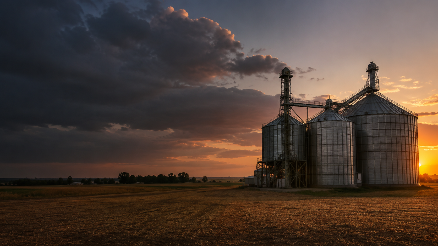 Farm silos at sunset
